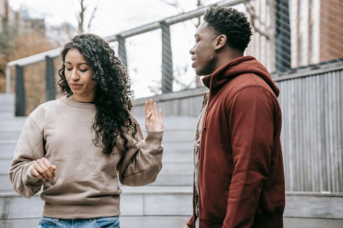 A woman showing hints of being secretly smart by setting boundaries in a conversation.
