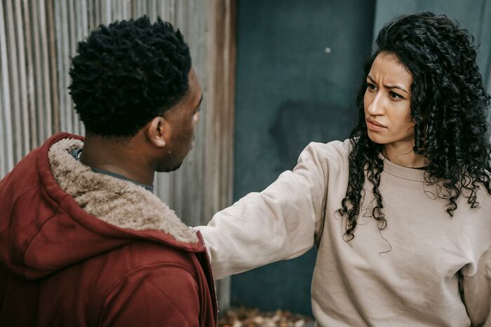 Woman confronting man with intense expression representing savage women verbal weapons