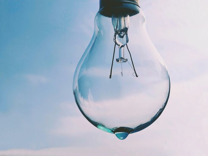 A light bulb with a drop of water, symbolizing a crazy, yet true fact about Wyoming's 2 escalators.