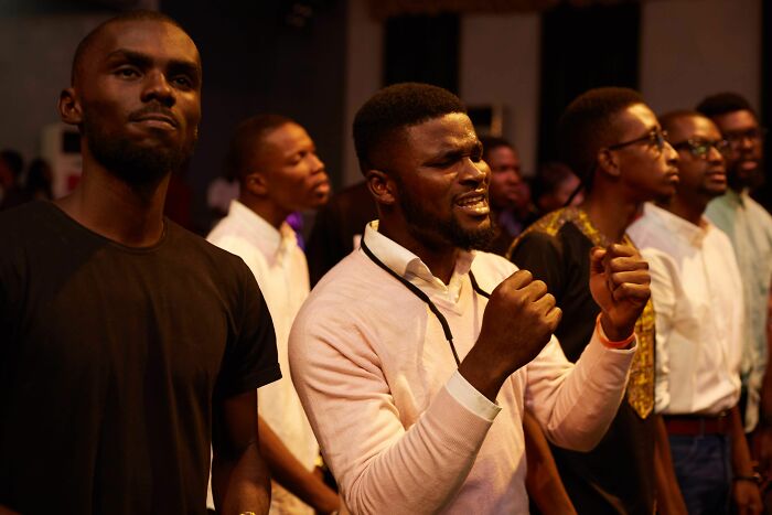 Men passionately singing, capturing wild coincidences that happened to people.