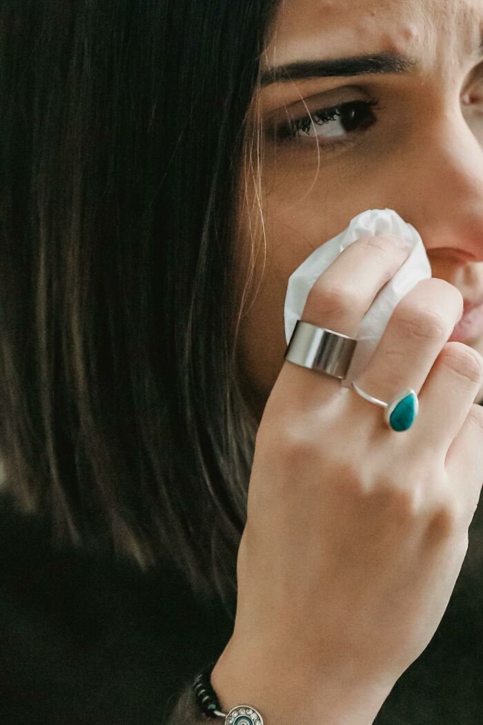 Sad woman wiping tears with a tissue depicting entitled parent emotions