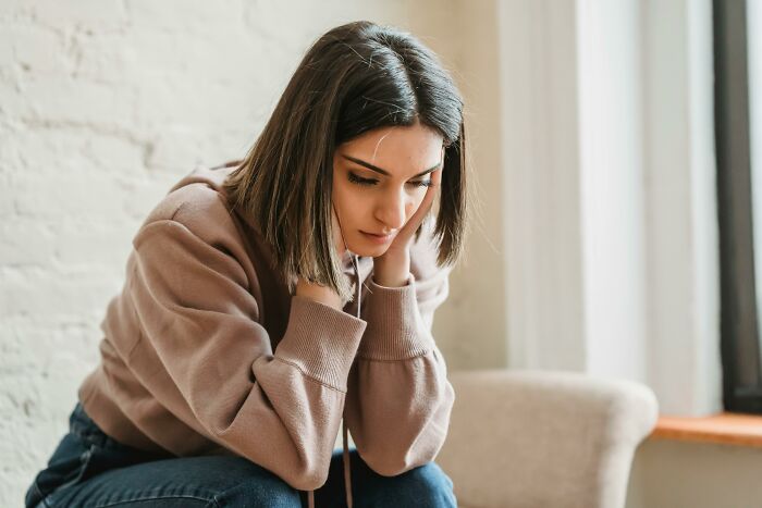 Sad woman looking down feeling hurt about cheating partners