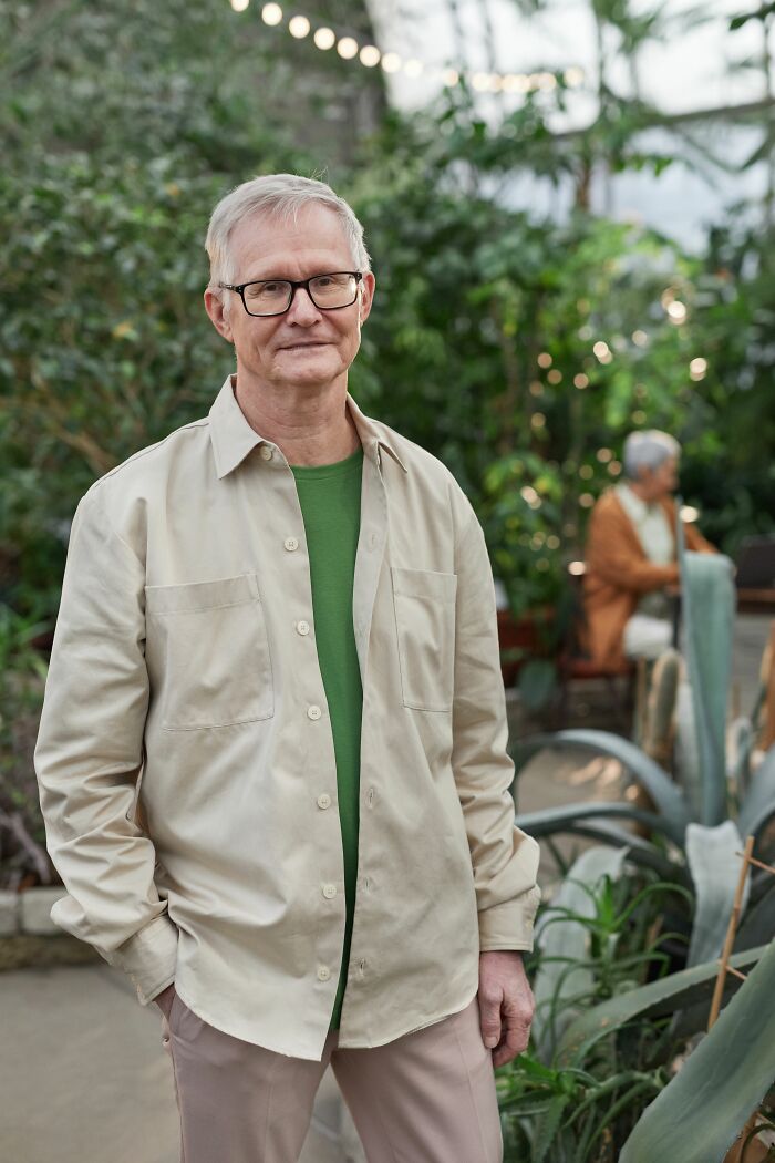 An older man with glasses, demonstrating the diversity of human bodies.