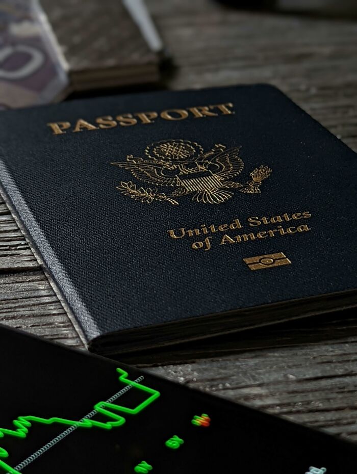 Close up of United States passport on table near smartphone