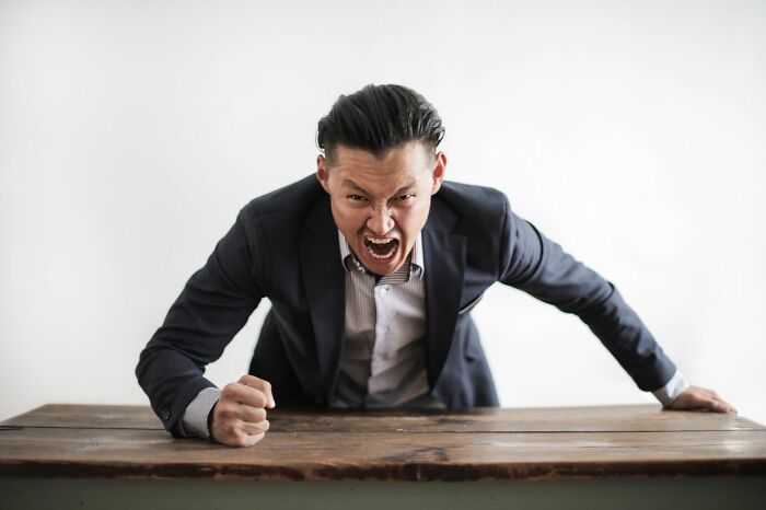 An angry man in a suit, capturing the intensity of courtroom stories and legal insiders.