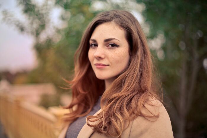 A woman with freckles looking at the camera, showcasing the diversity of human bodies and their NSFW facts.