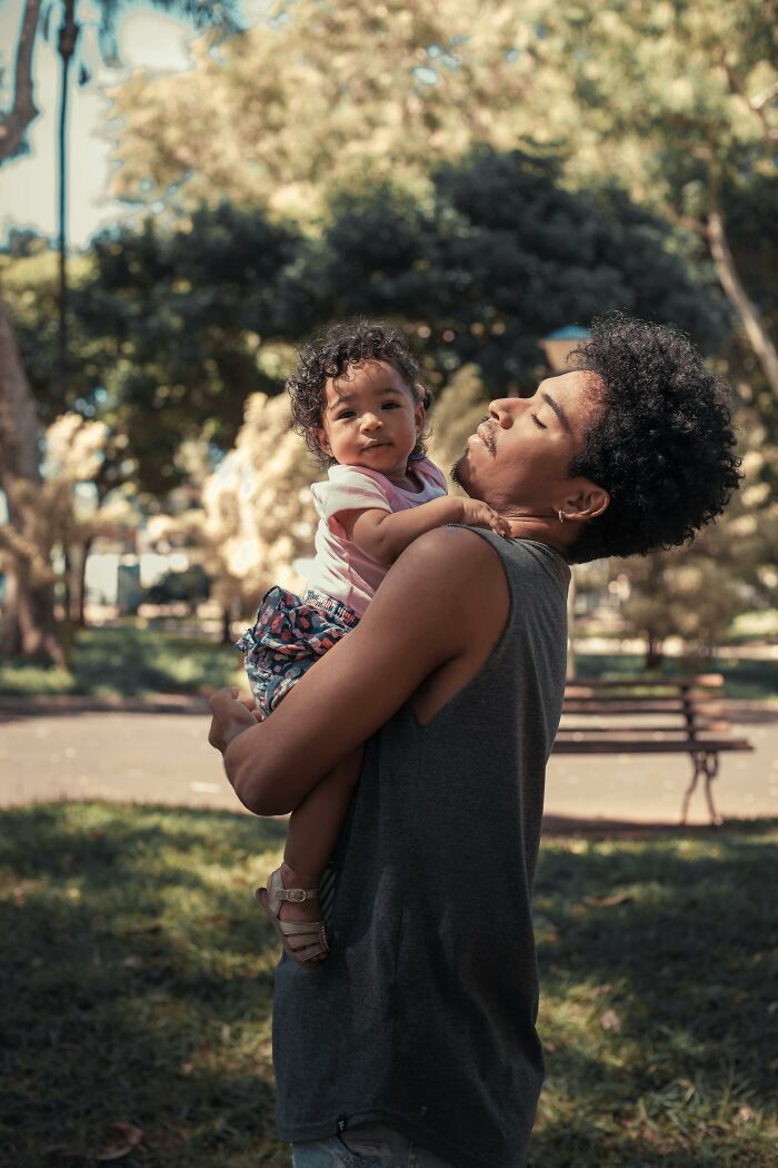 Father holding child in park depicting moments men realized their lives would never be the same