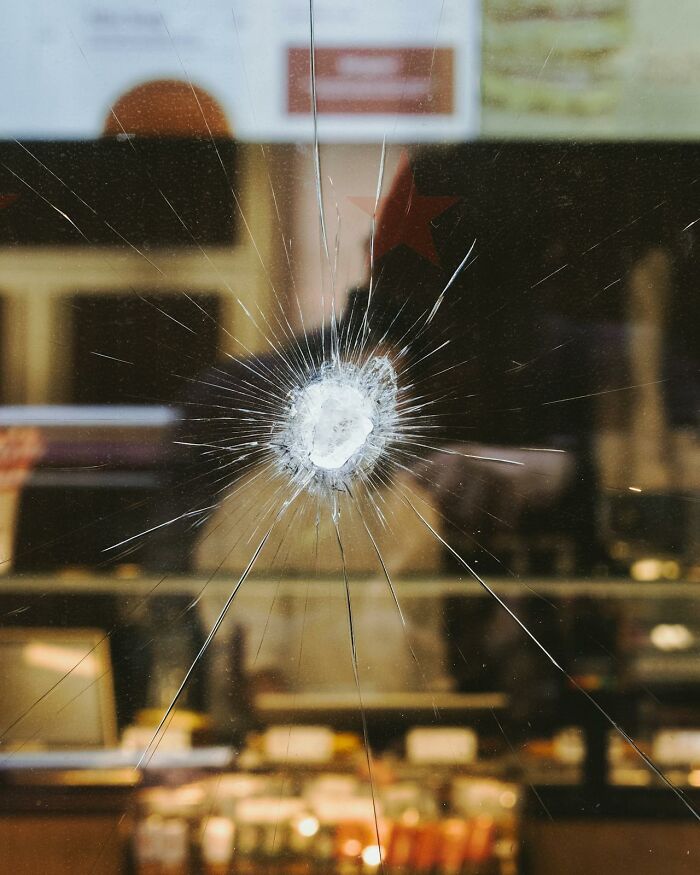 Close up of a cracked glass window with star-shaped impact