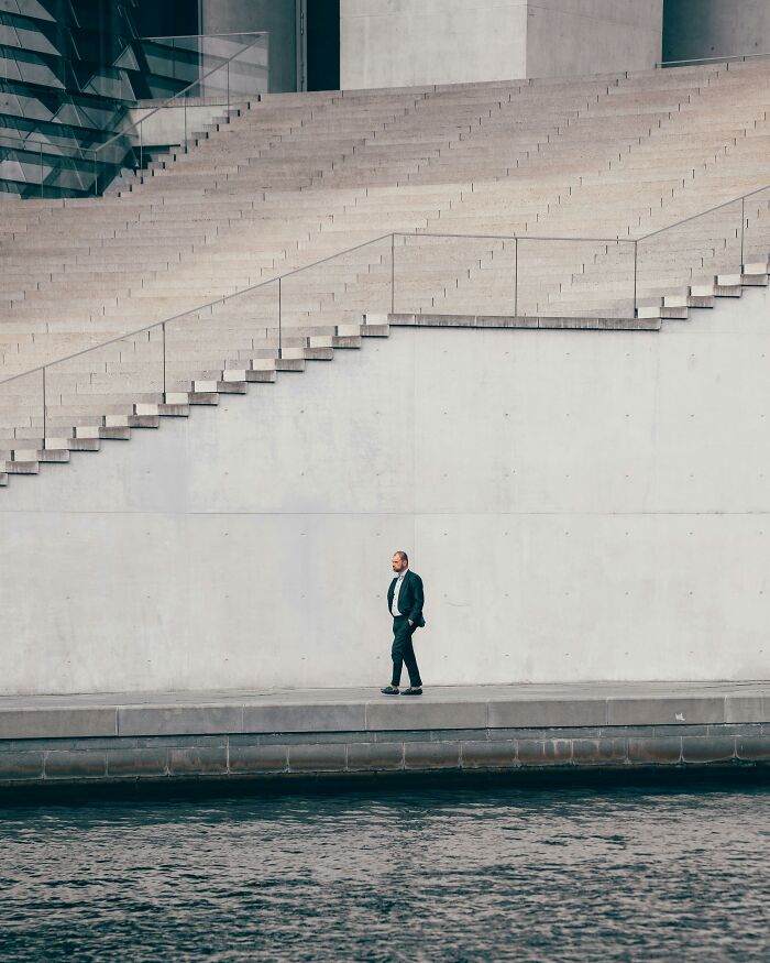 Man walking alone by water, contemplating life changes after cheating