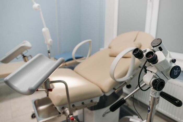 An empty medical examination chair in a doctor's office, representing various types of pain and discomfort people experience.