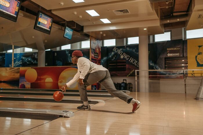 Man bowling at indoor bowling alley with bowling ball