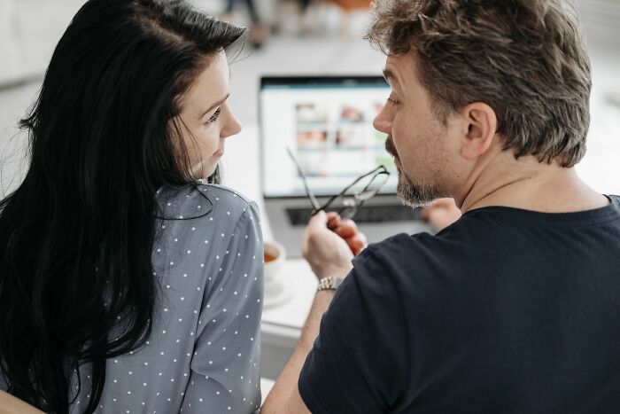 Man and woman facing each other closely in a serious discussion about verbal weapon