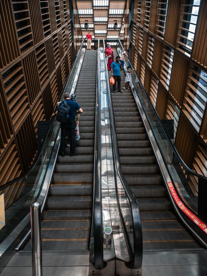 An upward view of multiple escalators in a modern building, highlighting surprising Wyoming escalator facts.