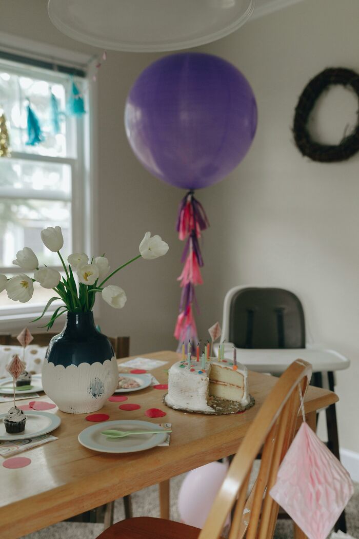 Birthday party table with cake and balloon symbolizing changed life
