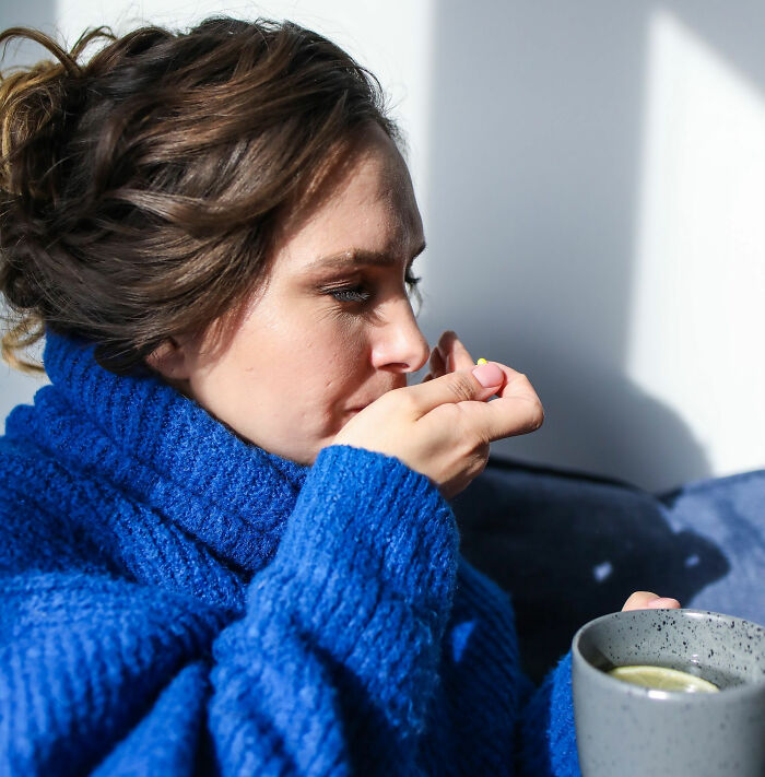 Woman taking a pill and drinking tea, a moment women decide to marry their partner.