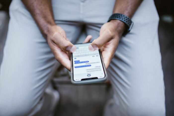 Close-up of a person holding a phone with text messages, revealing worst things on partners phone.