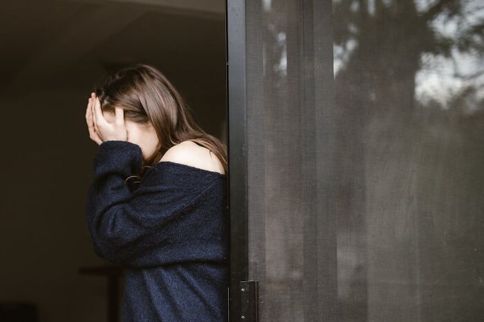 Woman covering face showing distress over infidelity story