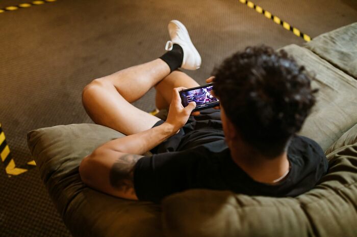 A person casually using their phone, potentially showing what people found on their partners phone.
