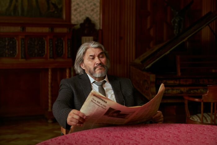 A man reads a newspaper, reflecting on courtroom stories that are too wild to be real.
