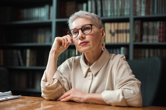 A thoughtful woman, possibly contemplating worst things people found on partners phone.