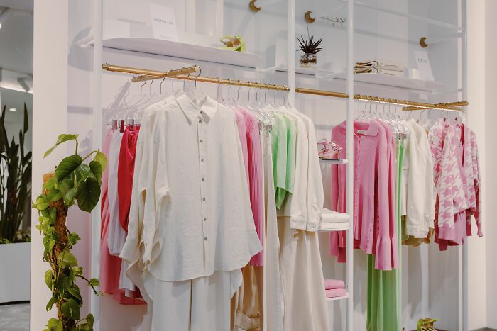 A display of clothes in a store, showcasing human bodies in fashion.