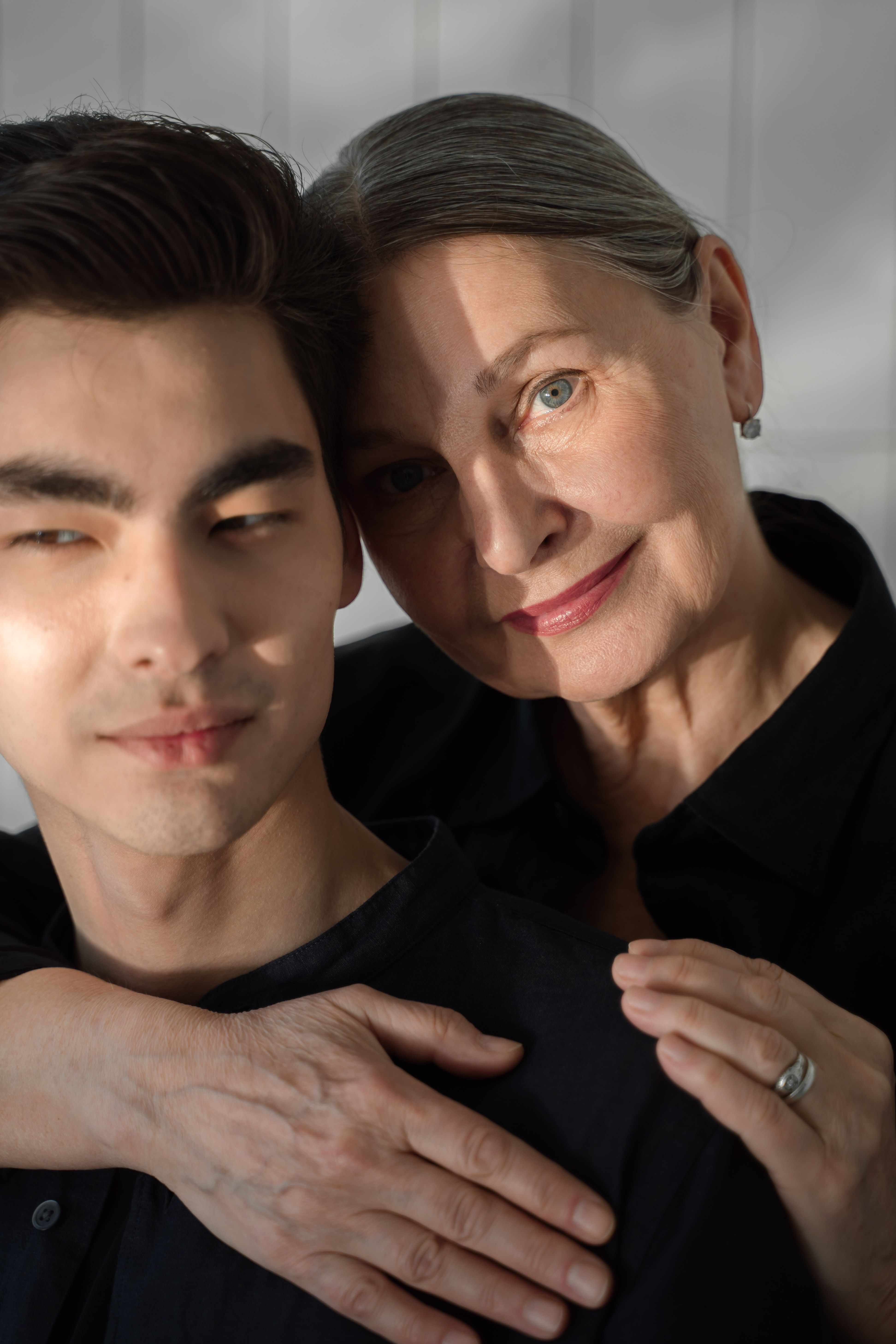 Older woman hugging younger man reflecting mother in law relationship