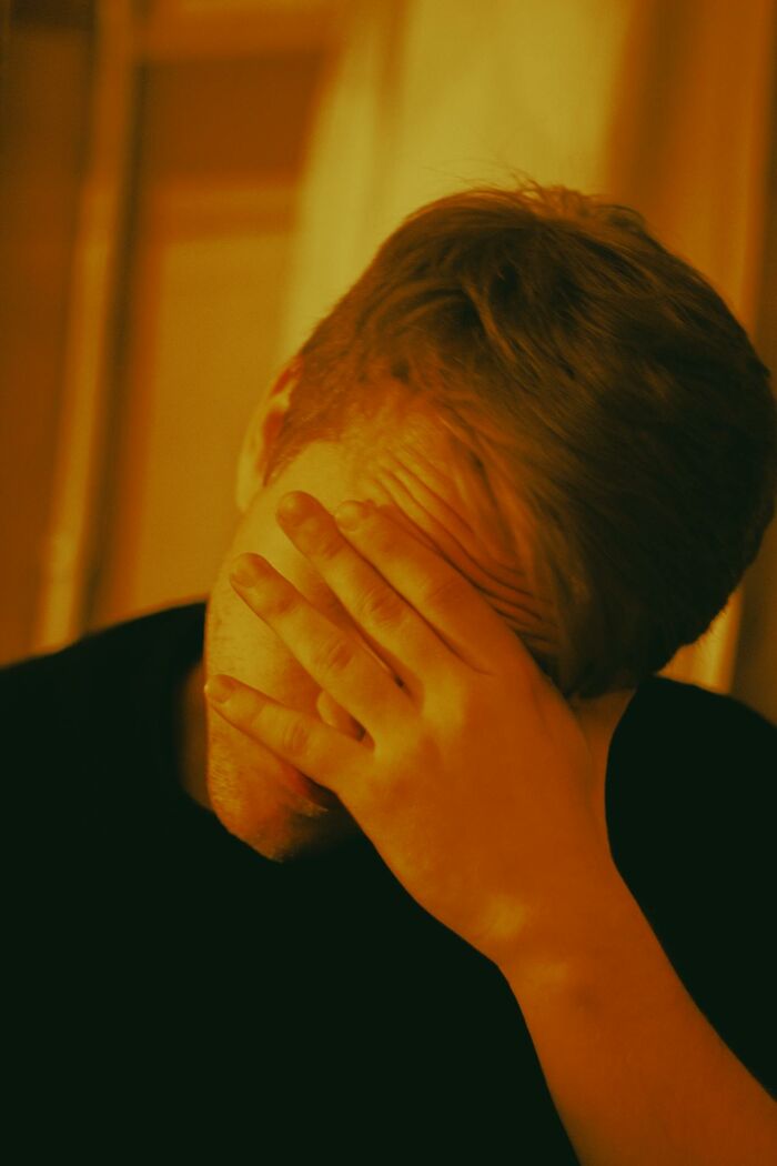 Man with hand on face showing diving stress or fear