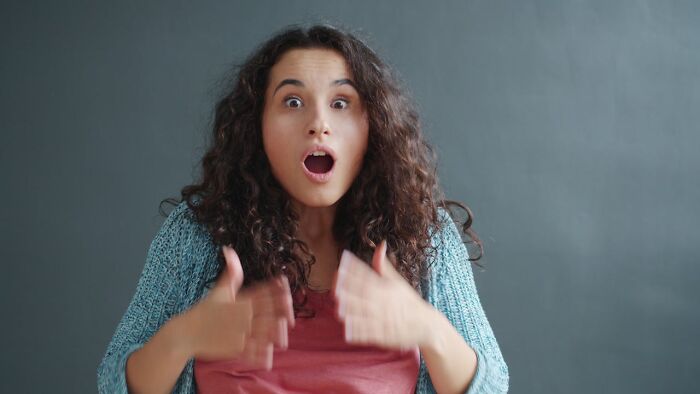 Surprised woman reacting with wide eyes to shocking infidelity news