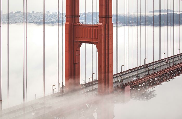 Close-up view of the Golden Gate Bridge tower emerging through fog