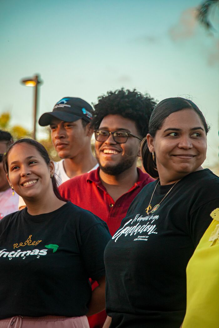 Group of diverse people smiling outdoors, showing different aspects of human bodies.