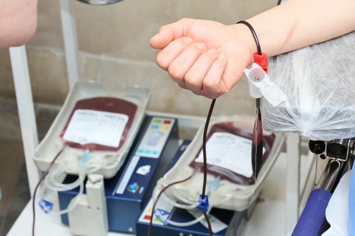 A person donating blood with bags of blood visible, showcasing true facts and Wyoming's unique escalator situation.