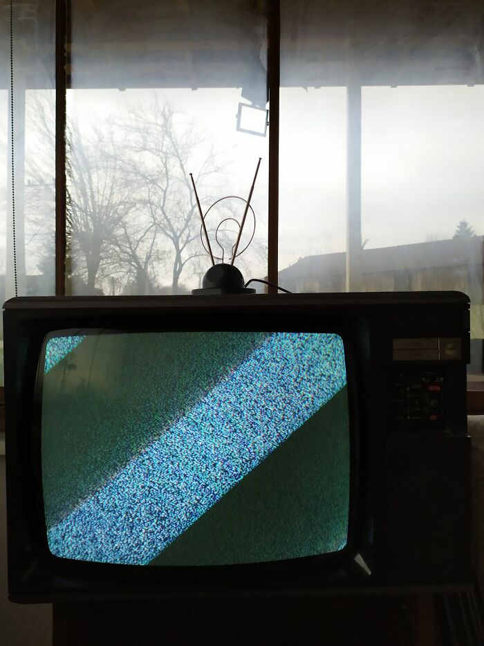 A vintage television displaying static on the screen, reflecting unexplained experiences people still can't explain.