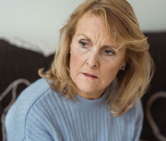 A portrait of a distressed woman, representing the daughter tricked by her mom into eating gluten free food.