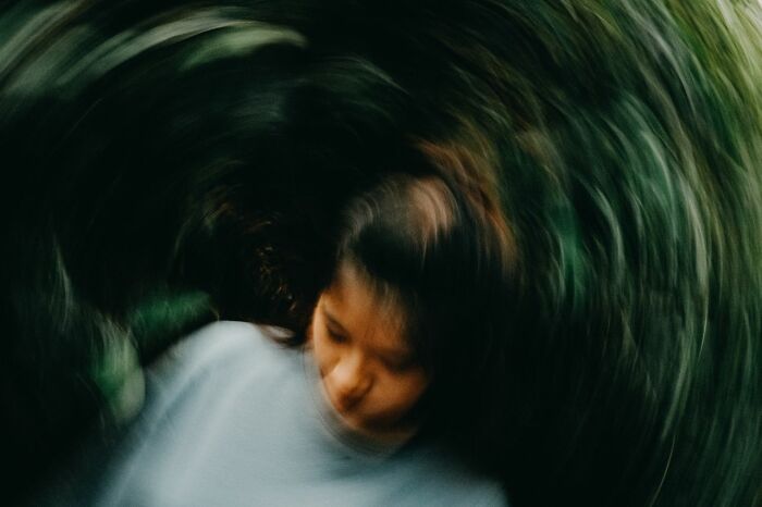 A blurred image of a person, conveying dizziness or disorientation, potentially leading to an unserious ER visit.