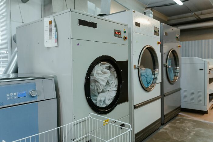 Large industrial washing machines in a laundry room. People simply couldn't take it anymore when their clothes were dirty and snapped.