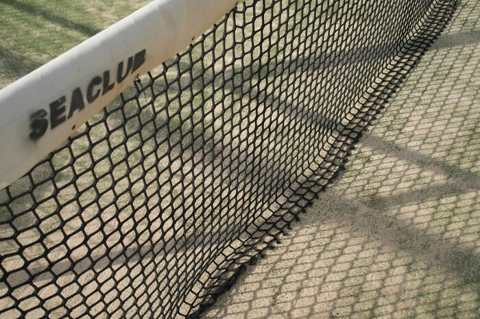 Tennis court net with a Seaclub logo, representing a crazy fact about Wyoming's few escalators.