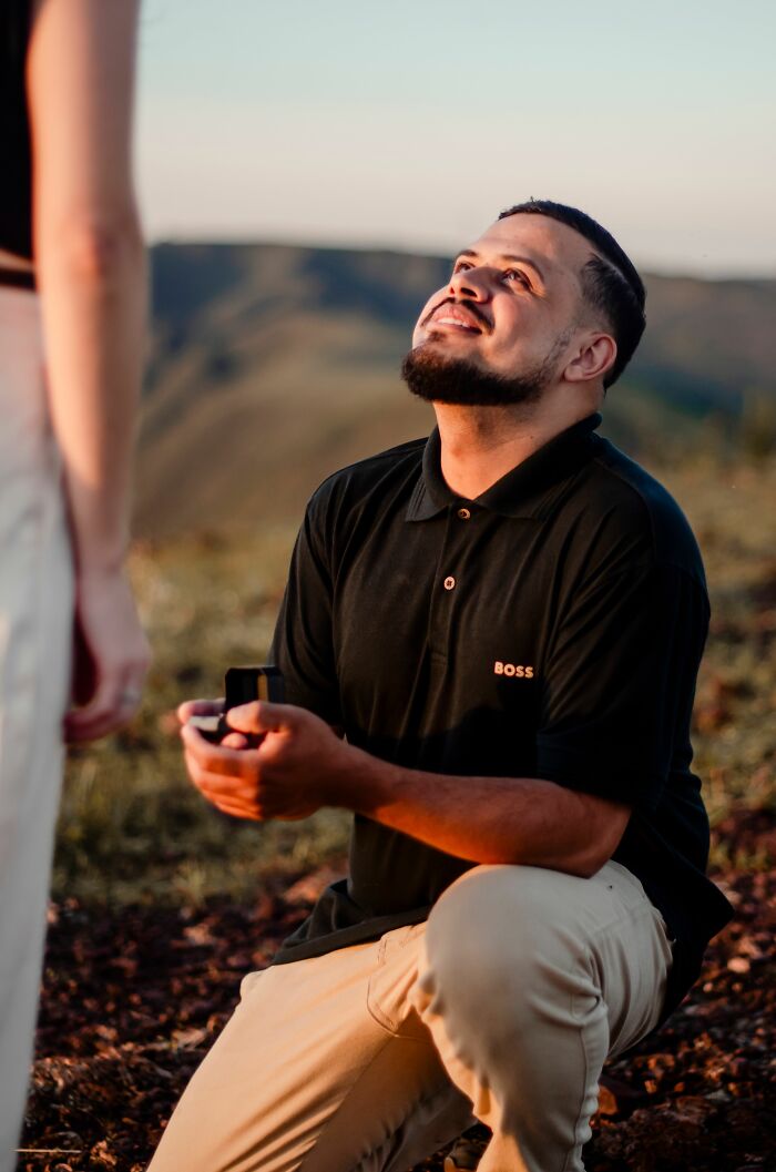 Man proposing marriage outdoors at sunset
