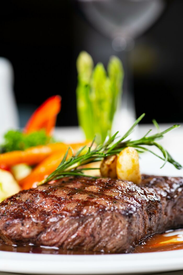 Grilled steak with herbs and vegetables on white plate food facts