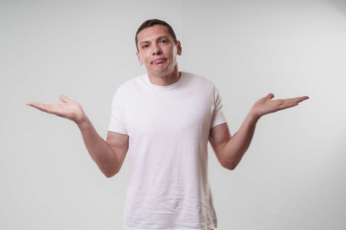Man shrugging, confused by wild courtroom stories.