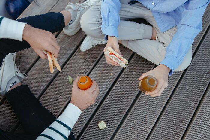 People eating sandwiches and drinking, a moment of calm before possibly going full rage mode.