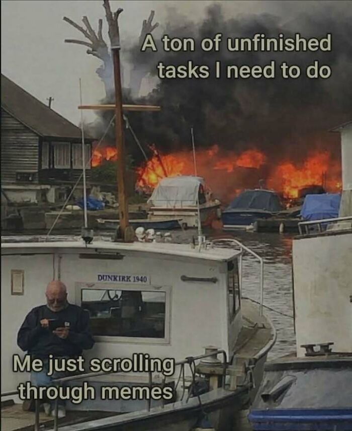 A meme showing a man scrolling on his phone while boats burn in the background, a fever dream.