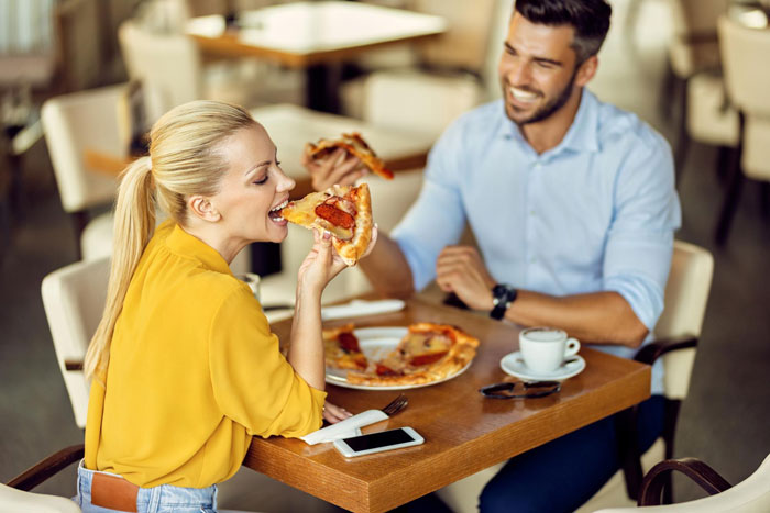 A happy couple enjoying pizza together, reflecting on a picky eater girlfriend relationship. A happy couple enjoying pizza together, reflecting on a picky eater girlfriend relationship.