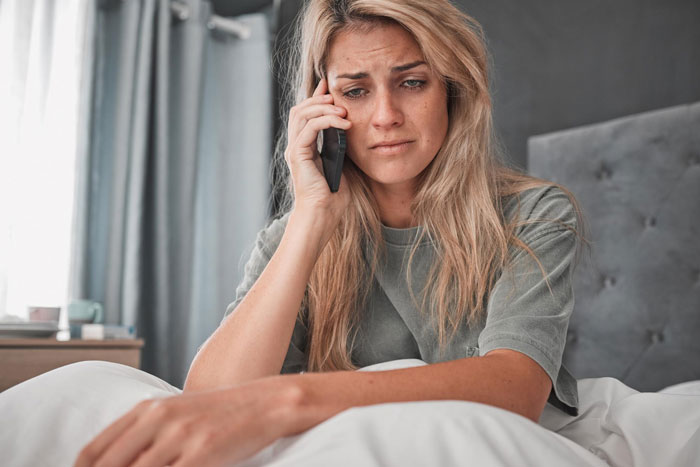 A sad woman on the phone, possibly discussing issues with a picky eater girlfriend relationship. A sad woman on the phone, possibly discussing issues with a picky eater girlfriend relationship.