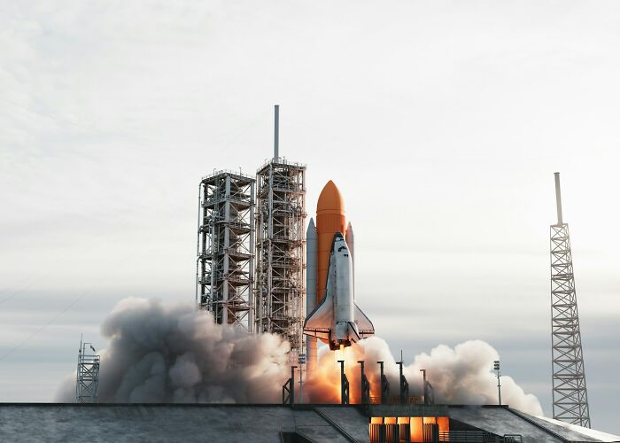 A space shuttle launching, a complex but silly solution to space travel.