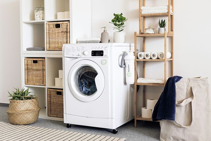 Laundry room with washing machine and organized shelves
