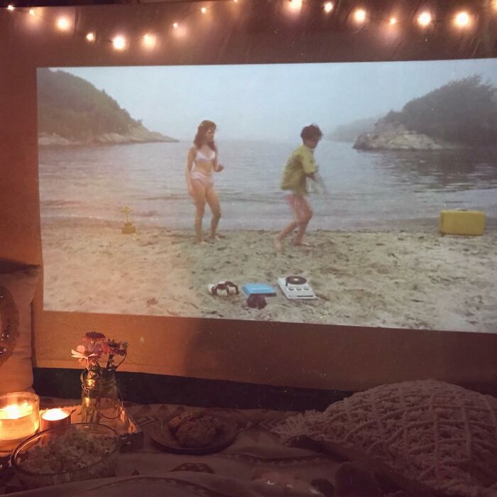 Cozy home movie night projector setup with decorative lighting for Father's Day gifts