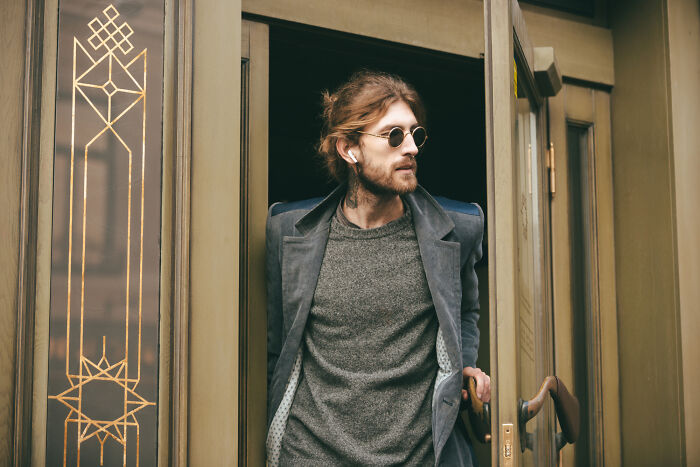 Man in glasses and coat exiting building symbolizing meeting a psychopath