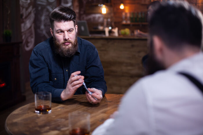 Man showing manipulative behavior in tense conversation, symbolizing meeting a psychopath