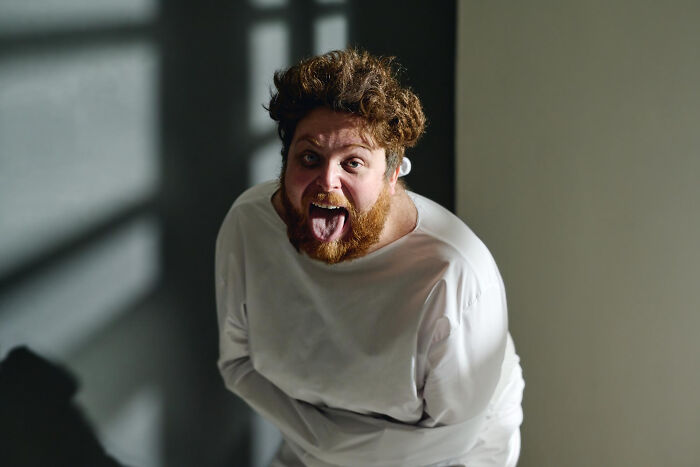 Man in a straitjacket acting wildly, representing signs of a psychopath
