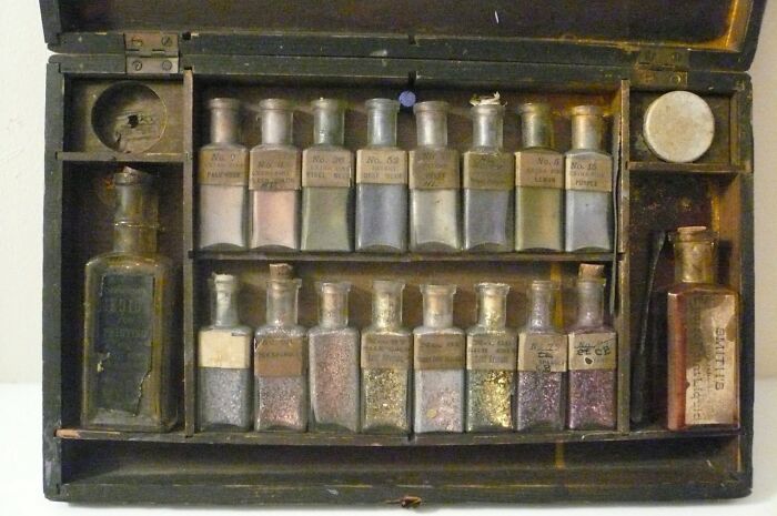 An antique wooden box filled with small glass bottles, an interesting object that is still intact after all these years.
